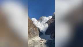 Huge avalanche races down mountain into glacier lake in Nepal