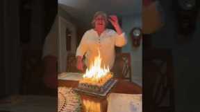 Grandma struggles to blow out dozens of candles on birthday cake