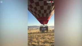 Hot air balloon pilot expertly lands onto back of truck