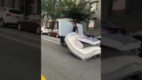New Yorker drags two mattresses on a Motorcycle