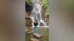 Epic Fail Happens in Background of Woman's Scenic Waterfall Photo