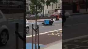 Domino's delivery driver topples off moped while performing wheelie