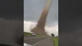 Incredible footage of a large tornado slowly crossing the road in Colorado, USA