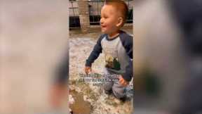 Adorable moment little boy sees snow for the first time
