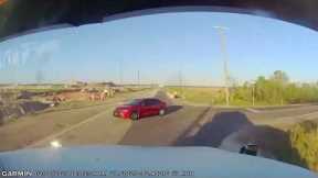 Oblivious sedan driver turns in front of truck and barely avoids fatal collision