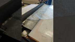 Very satisfying! Sheet of bubble wrap goes through rolling press