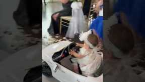9-month-old flower girl drives down wedding aisle
