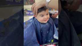 Adorable baby can't stop smiling while getting a hair cut