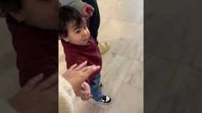 Toddler throws toy so he can hold moms hand