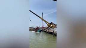 Crane falls into the SEA trying to lift huge boat