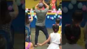 Supportive father dances with daughter