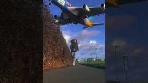 Large plane flies right above woman jogging outside Heathrow Airport