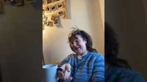 Mom laughs as she realises what the mug says