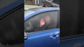 Man fearlessly punches through his car window...