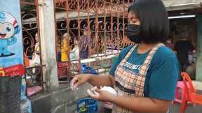 Food vendor rapidly flicks rice balls into pot like machine gun