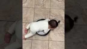 Baby takes a ride on roomba vacuum