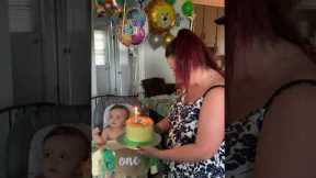 Toddler hugs his first-ever birthday cake
