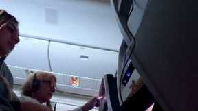 Plane passenger tries to stop woman from reclining her seat
