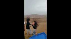 Tourists' hair stands on end in desert due to electrified clouds