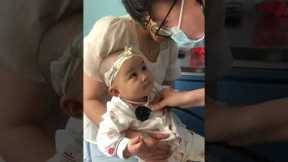 Cheeky toddler winks at doctor during checkup