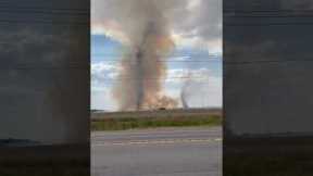 Rare moment two fiery dust devils spotted over farmland