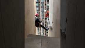Resident gives lunch to workers abseiling down tower block