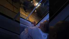 Baby is captivated by fireworks display