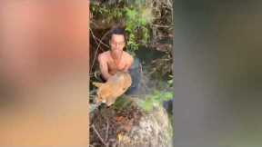Firefighter climbs into pond to rescue stranded puppies