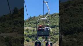Siblings play fight on chair lift