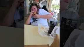 Hungry pigeon tries to eat woman's McDonald's burger