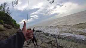 Fisherman celebrates catch right before giant wave hits him