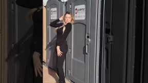 Influencer posing against porta potty get hit by door when occupant kicks it open