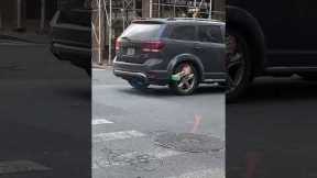 NYC driver causes a scene loudly driving around with boot lock on vehicle tire
