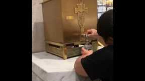 Woman Bottles Holy Water From NYC Cathedral